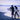 person walking on seashore holding surfboard