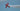 red and white plane flying in the sky