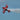 red and white plane flying in the sky