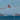 a small plane flying over a body of water