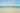 a sandy beach with waves crashing