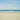 a sandy beach with waves crashing