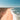 a sandy beach with a body of water in the background