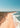 a person flying a kite on a beach