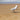 a seagull walking on the sand of a beach