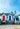 a row of beach huts sitting on top of a sandy beach