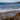 Waves crash onto a rocky beach near the ocean.