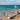 A beach with a clear sky and warning signs.