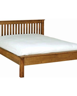 a bed in a room with a wooden headboard 